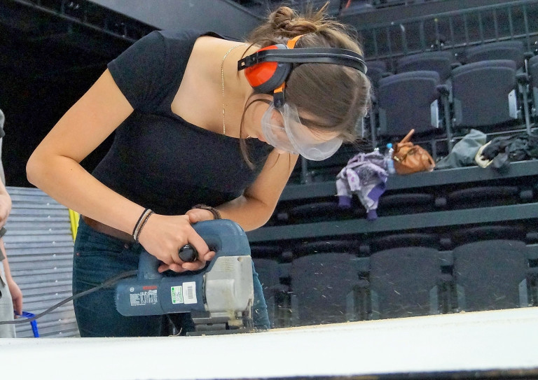 Kobieta pracująca przy montażu wyposażenia hali