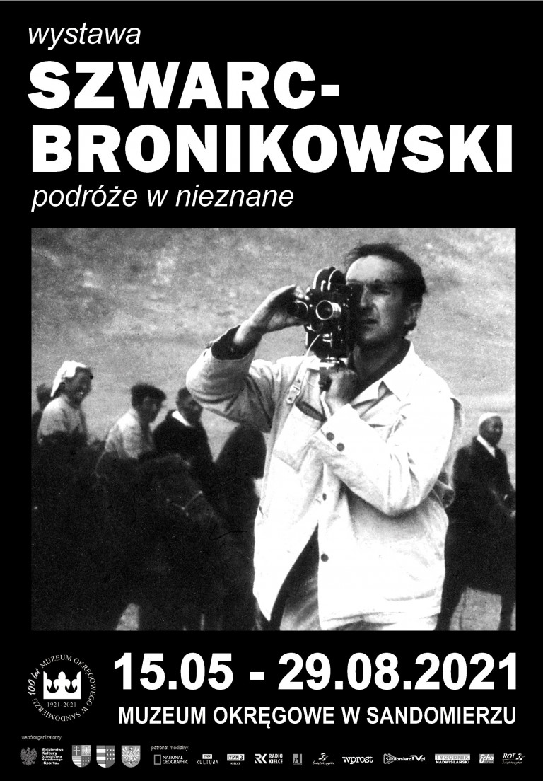 Wystawa W Muzeum Okręgowym W Sandomierzu Poświęcona Stanisławowi Szwarc Bronikowskiemu . Na Pierwszym Planie Mężczyzna Z Kamerą Na Ramieniu. W Tle Przechodzi Grupa Osób.