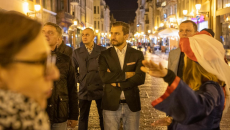 Grupa osób stojąca na ulicy, wieczór