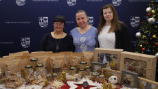 Podopieczne Zakładu Aktywności Zawodowej Manufaktura Pietraszki pozują do zdjęcia ze świątecznymi ozdobami i smakołykami wykonanymi w placówce