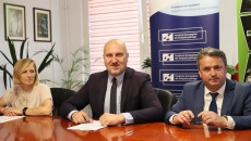 Grzegorz Socha I Burmistrz Staszowa Siedzą Prz Stole, Obok Nich Siedzi Kobieta W Jasnej Bluzce
